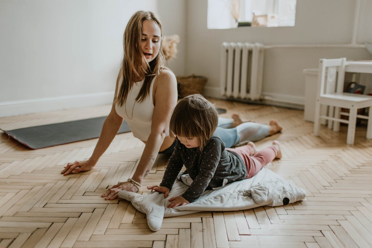 A mother and child practicing yoga together at home on a sunny day, fostering wellness and connection.